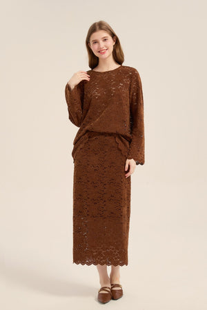 Full-length photo of model wearing a chestnut lace long-sleeve blouse and matching lace midi skirt, paired with brown flats.