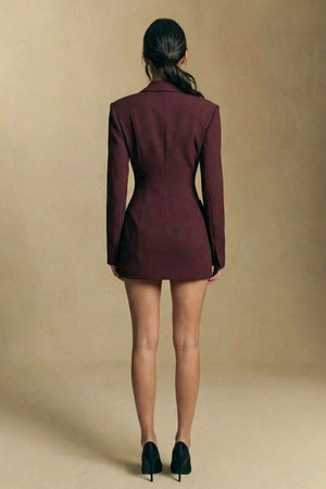 Back view of the burgundy blazer mini dress, revealing a clean tailored silhouette with structured shoulders and a smooth fitted back line.
