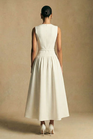 Back view of an ivory halter neck maxi dress with floral embroidery, revealing the clean back line and smooth, elongated silhouette.