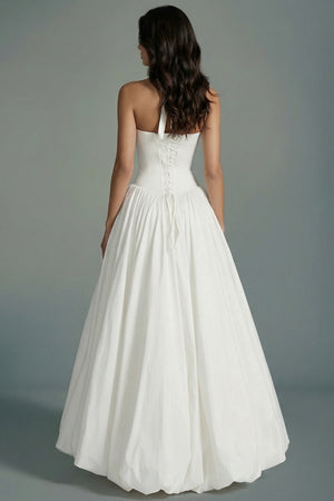 Back view of an ivory halter corset maxi dress showcasing lace-up corset detailing, open shoulders, and a full flowing skirt falling to ankle length.