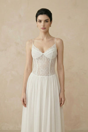 Close-up of an ivory lace corset maxi dress highlighting the floral lace bodice, delicate spaghetti straps, and softly gathered waist.