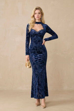 Front view of a navy floral velvet maxi dress featuring a lace-trimmed sweetheart neckline, long fitted sleeves, and a body-skimming silhouette, styled in a minimal studio setting.