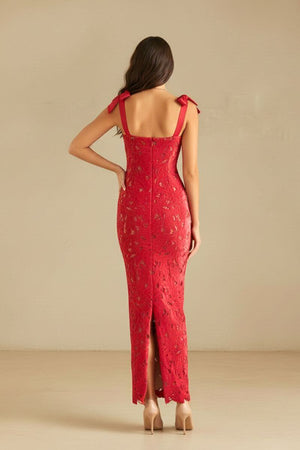 Back view of the red lace dress with bow straps, exposed zipper, and back slit, showing the fitted lace silhouette.