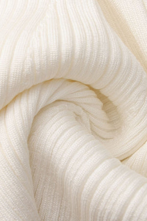 Close-up of soft white ribbed knit fabric showing its textured stretch pattern and smooth woven details.