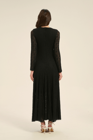 Back view of black lace long sleeve maxi dress with flowing hem and delicate lace texture.