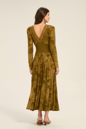 Back view of olive green floral lace-trim maxi dress with deep V neckline, lace trim, and pleated skirt.