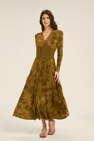 Side angle of olive green floral lace-trim maxi dress with pleated flowy skirt and buttoned waist detail.