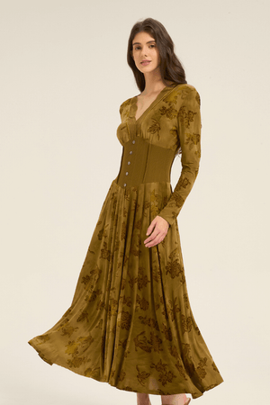 Side view of olive green lace-trim maxi dress featuring long sleeves, cinched waist, and flared hem.