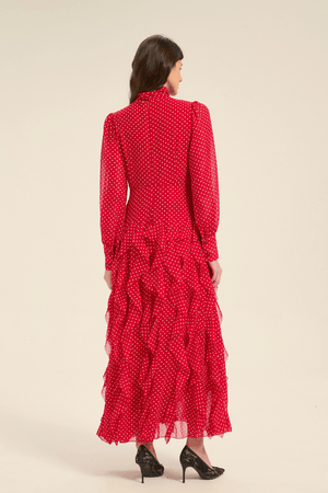 Back view of red polka dot midi dress with tiered ruffle skirt and long sleeves.