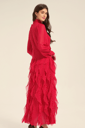 Side view of red polka dot midi dress with cascading ruffles and bow tie collar.