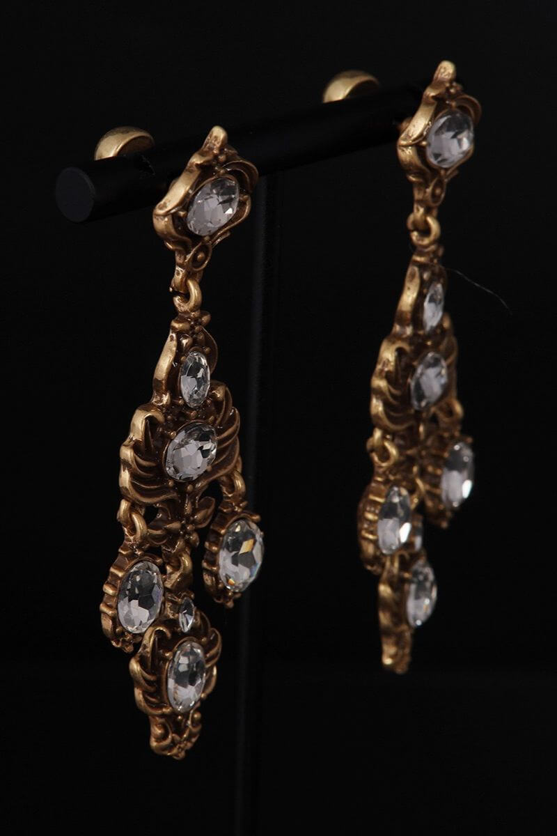Front view of matching antique gold chandelier earrings with multiple clear oval crystals arranged in a symmetrical vintage-inspired design.
