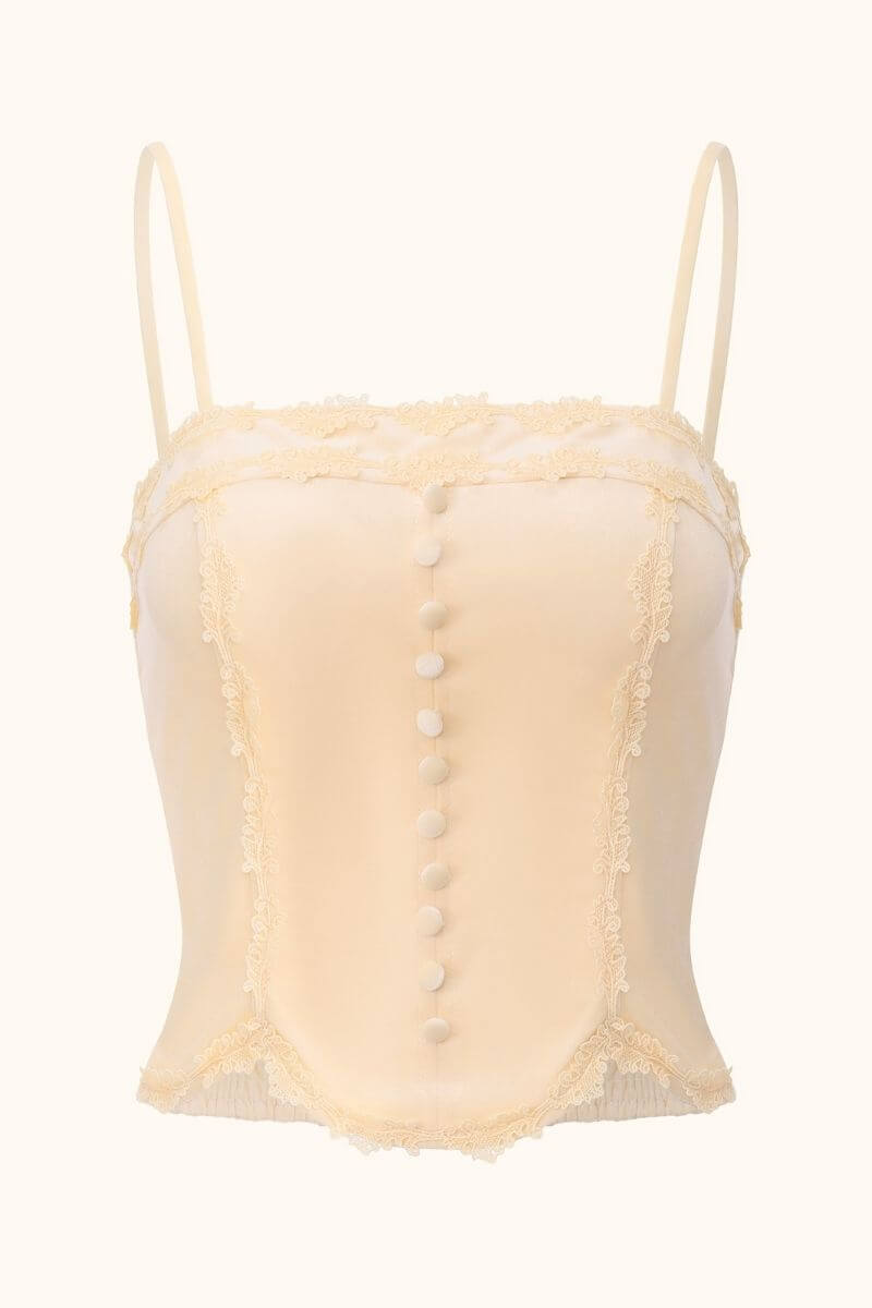 Front view of a beige satin corset top with lace trim, covered buttons, spaghetti straps, and vintage-inspired detailing, photographed on white background for Sioéne.
