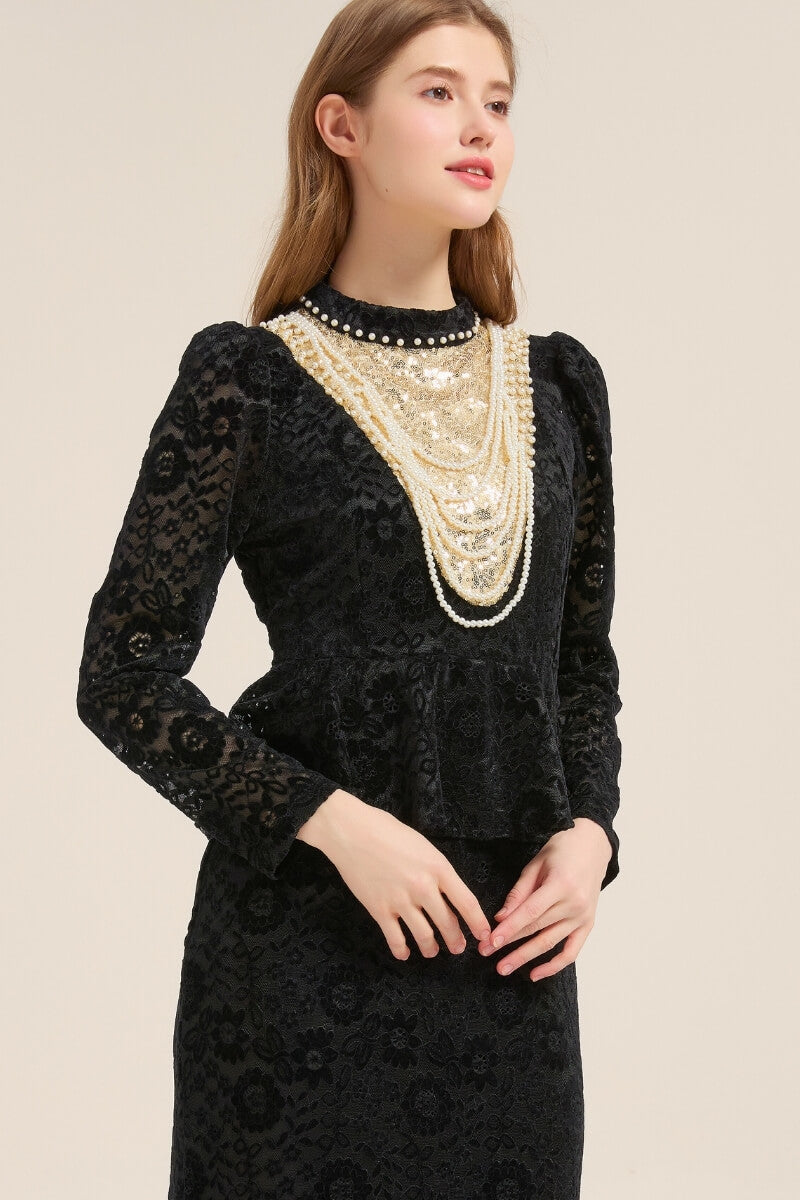 Side view of a black lace peplum midi dress with puffed shoulders, pearl and sequin collar details, and intricate floral lace texture, styled elegantly.