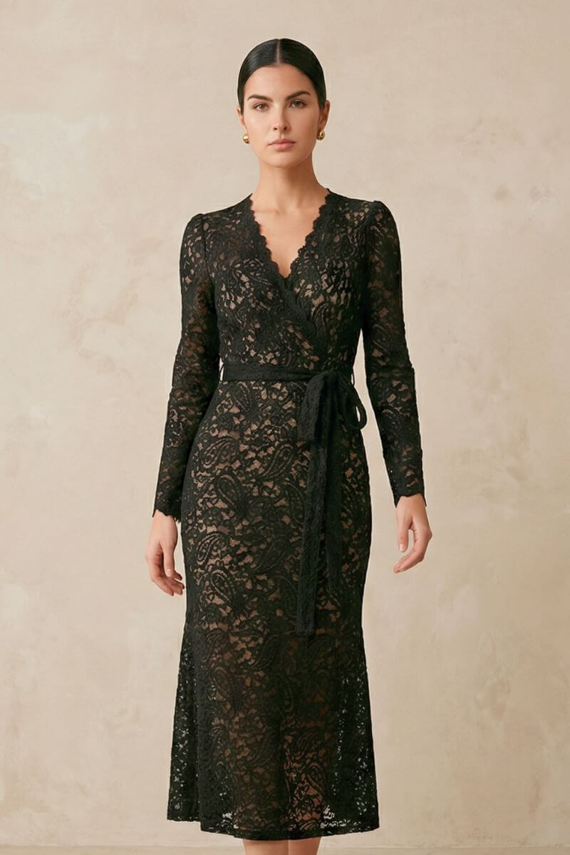 Front view of a model wearing a black lace wrap midi dress featuring intricate floral lace, a defined waist tie, long sleeves, and a softly flared hem.