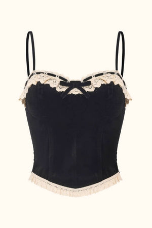 Front view of a black velvet corset top featuring thin straps, cream lace trim, and a small velvet bow, photographed on a white background for Sioéne.