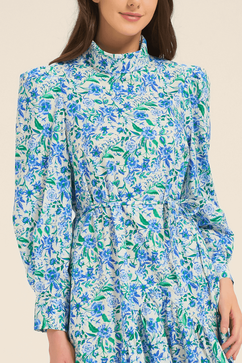 Close-up of the blue floral midi dress bodice showing high neck, puff sleeves, and waist detail.