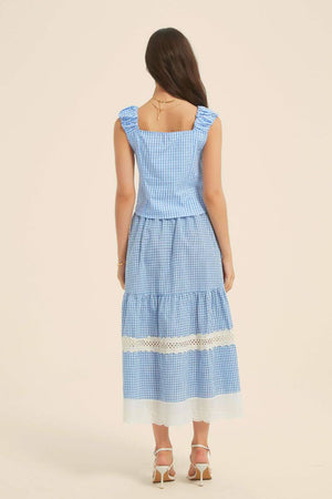 Back view of a blue gingham two-piece outfit showing a square neckline, ruched shoulder straps, and tiered skirt with lace trim.
