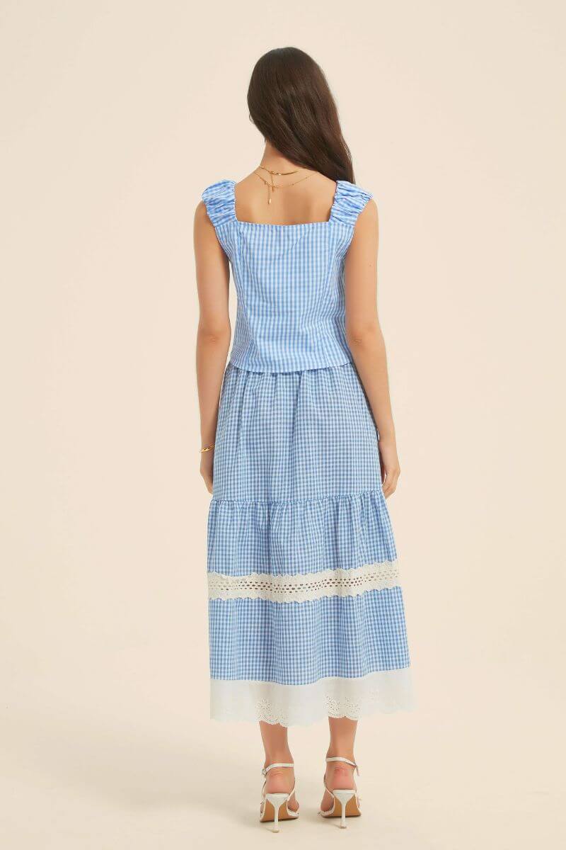 Back view of a blue gingham two-piece outfit showing a square neckline, ruched shoulder straps, and tiered skirt with lace trim.