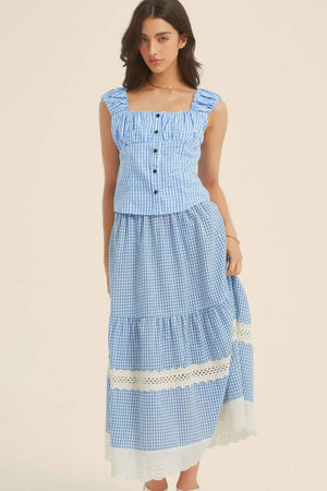 Front view of a blue gingham two-piece set with a ruffled-strap crop top and tiered maxi skirt featuring eyelet lace trims and soft gathers.