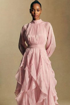 Back view of a blush pink chiffon maxi dress showing a soft bow tie at the neckline, gathered waist, and layered ruffle skirt flowing to the floor.
