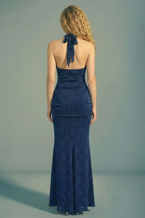 Model shown from back in a blush satin halter corset maxi dress with lace-up back detailing, gathered drop-waist skirt, and a soft bubble hem.
