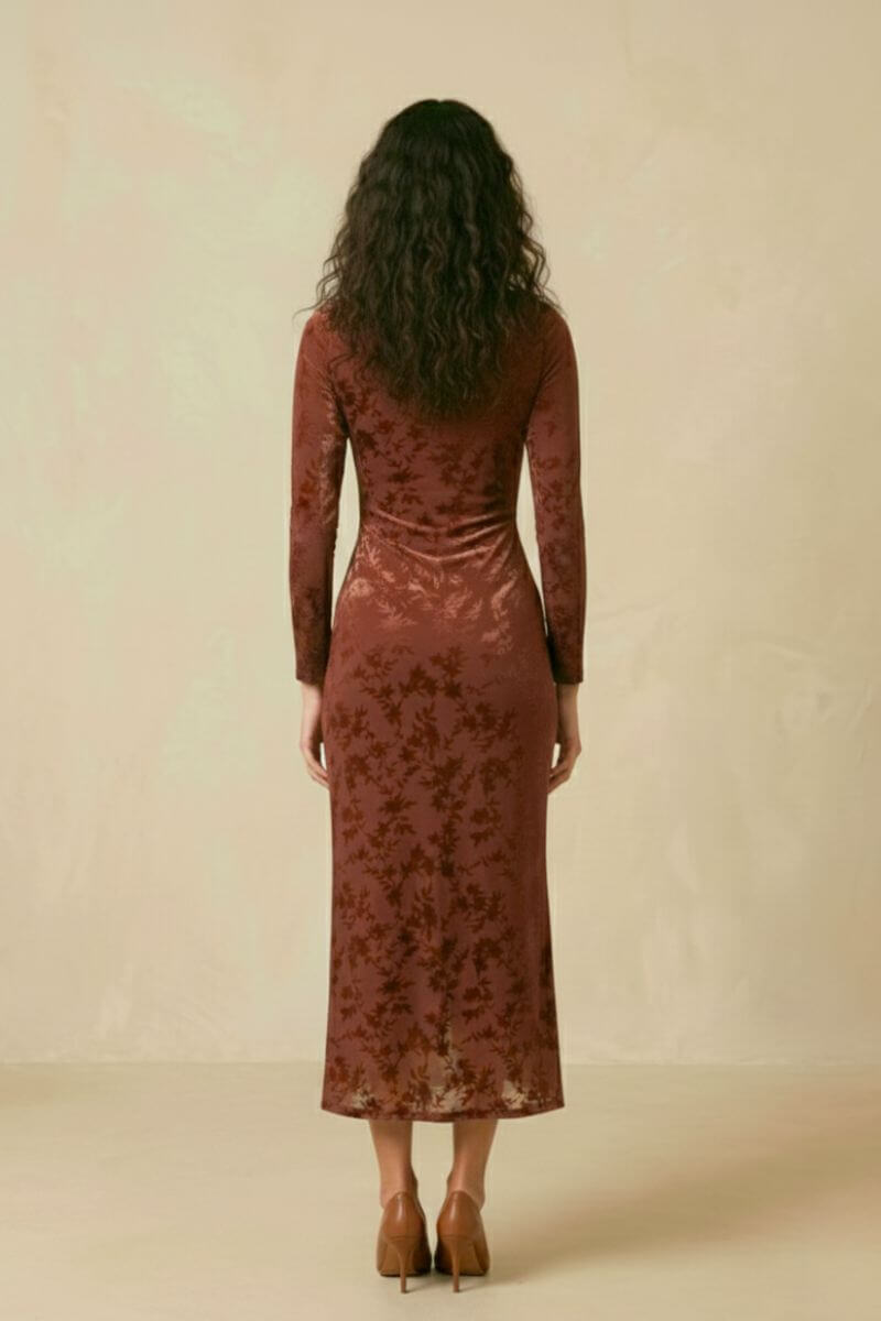 A woman shown from the back wearing a brown burnout velvet long-sleeve midi dress with a fitted silhouette and soft floral texture.