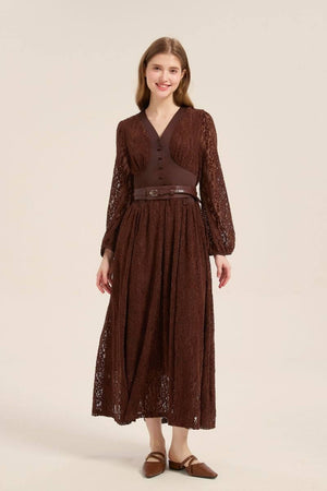 Model posing front view in a brown lace long sleeve maxi dress with a belted waist, vintage buttons, and romantic sheer lace overlay.