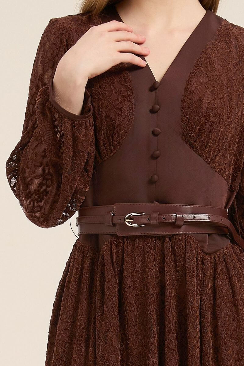 Close-up of brown lace dress showing fabric-covered buttons, delicate lace texture, and matching brown belt detail at the waist.