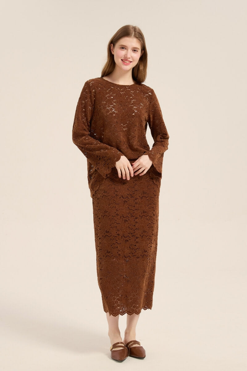 Model slightly angled in brown lace co-ord set with floral cutout details, scalloped hemline, and comfortable draped top.