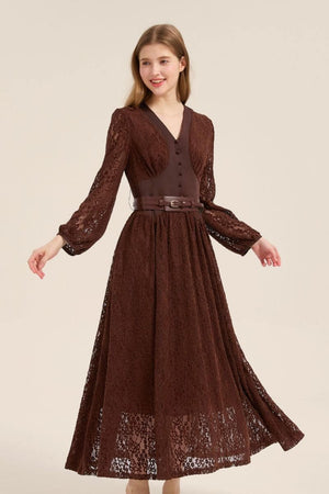 Model turning slightly in a brown lace V-neck maxi dress with puffed sleeves, belted waist, and soft flowy silhouette.