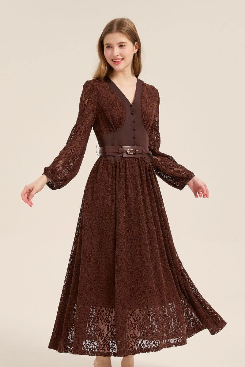 Model turning slightly in a brown lace V-neck maxi dress with puffed sleeves, belted waist, and soft flowy silhouette.