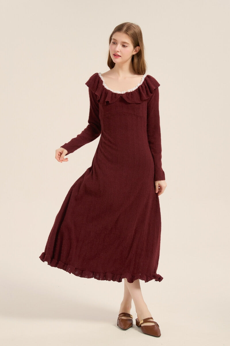 Model twirling in a burgundy knit midi dress featuring a ruffled neckline and hem, styled in a soft, feminine silhouette.