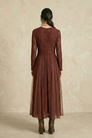 A back view of a burgundy lace midi dress showing the fitted bodice, long lace sleeves, and layered semi-sheer skirt with elegant movement.