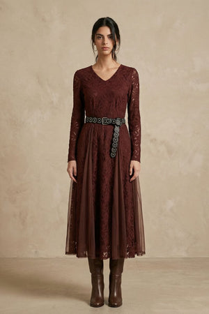 A front view of a burgundy lace midi dress featuring a V-neckline, fitted waist with a statement belt, sheer lace sleeves, and a flowing semi-sheer skirt.