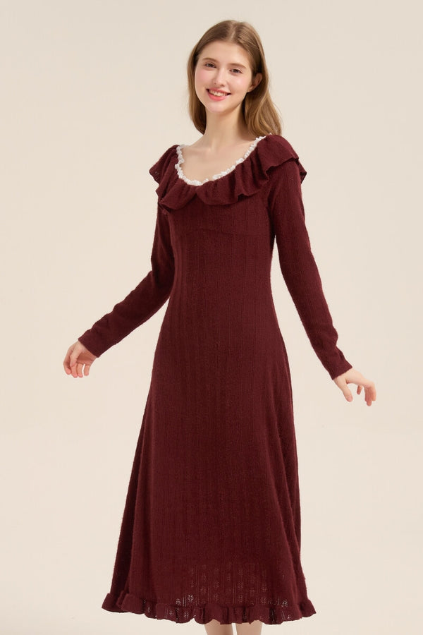 Model turning slightly, wearing a burgundy long sleeve knit midi dress with ruffled neckline and vintage-inspired charm.