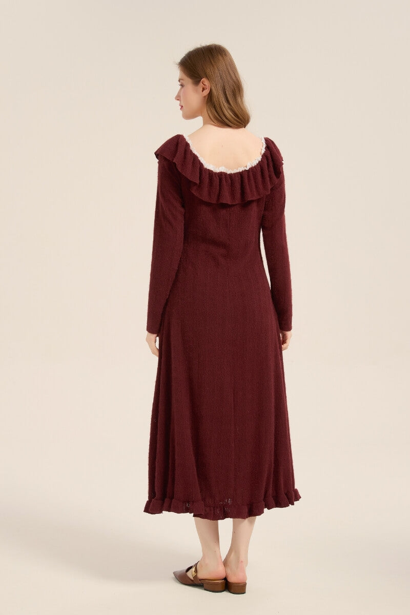 Model showing back view of a burgundy knit ruffle midi dress with scoop neckline and flared hemline.