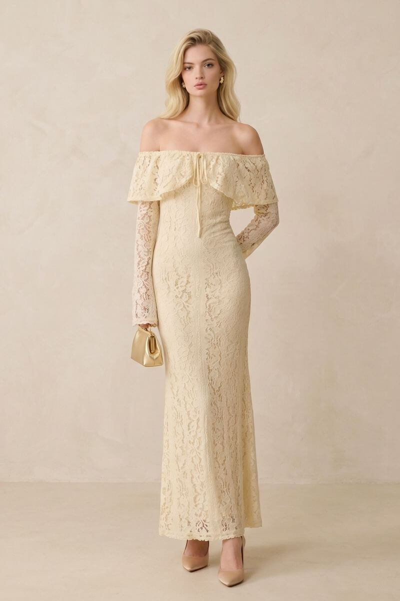 Model wearing a buttercream lace off-shoulder maxi dress with a fitted silhouette and long lace sleeves, styled with nude heels and a small gold handbag against a soft neutral studio background.