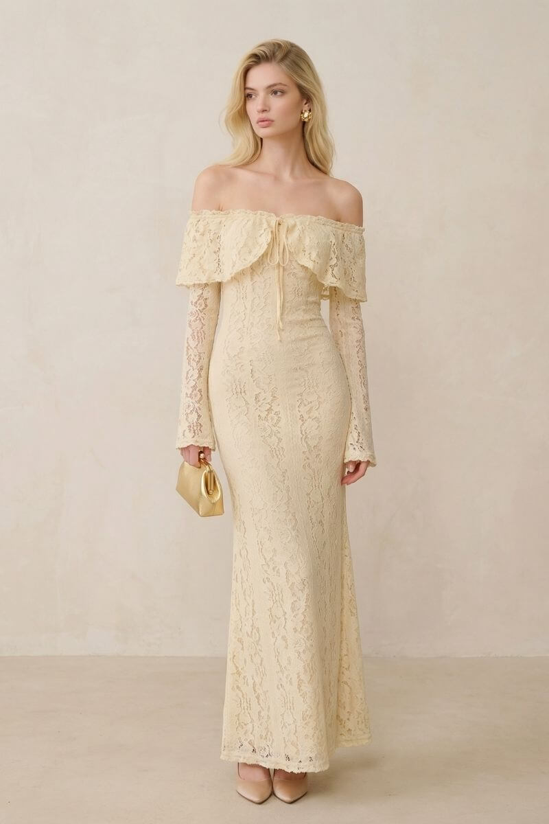 Model in a buttercream lace off-shoulder maxi dress shown from a slight angle, highlighting the delicate lace texture, structured waist, and elegant floor-length cut.
