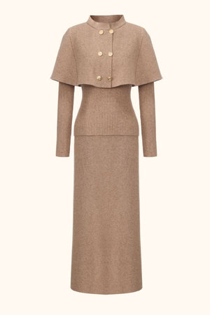 Front view of a camel knit two-piece set featuring a structured cape sweater with gold buttons and a matching ribbed-waist maxi skirt.