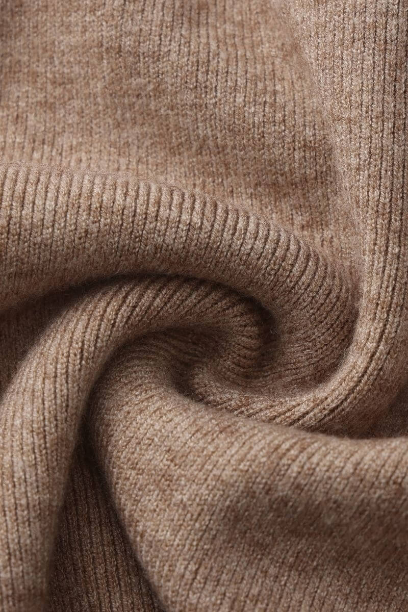 Close-up detail of soft camel ribbed knit fabric showing texture and weave for the sweater and skirt set.