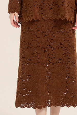 Close-up of brown floral lace fabric showcasing scalloped hem and intricate pattern of the midi skirt from the lace two-piece set.