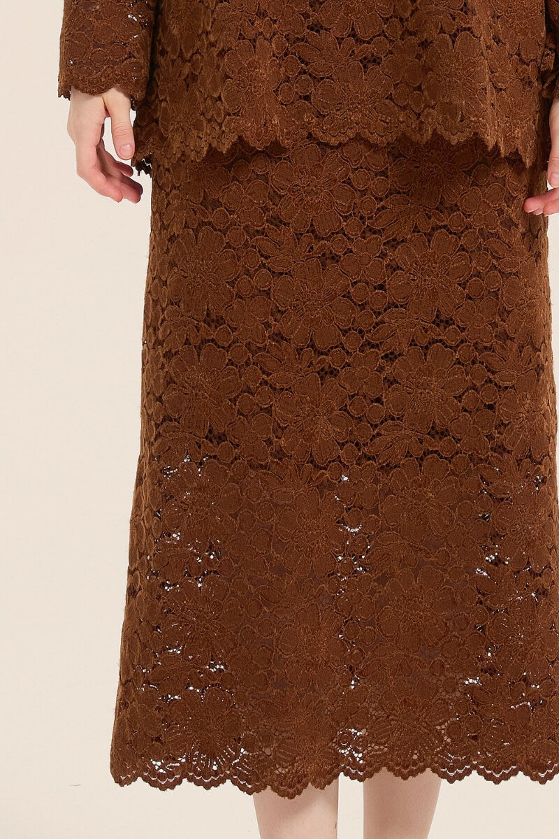 Close-up of brown floral lace fabric showcasing scalloped hem and intricate pattern of the midi skirt from the lace two-piece set.