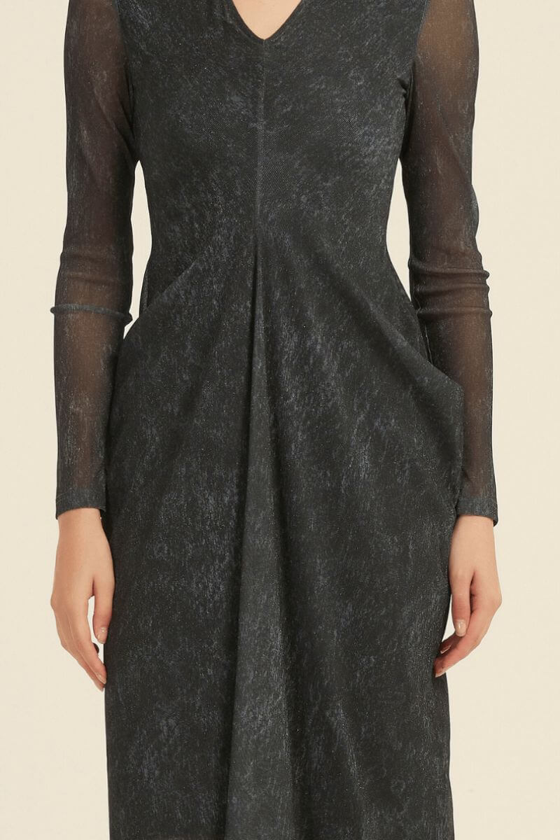 Detailed front close-up of a black V-neck midi dress highlighting the sheer sleeves, textured fabric, and central pleated drape.