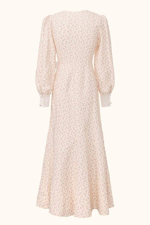 Back view of a cream midi dress featuring delicate pink floral print, long puff sleeves and a flowing A-line hem.