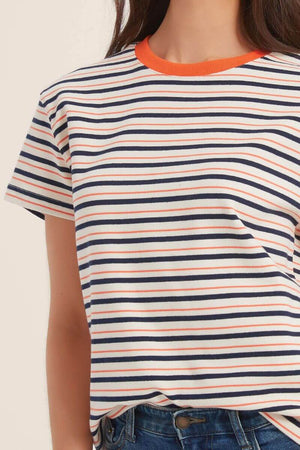 Close-up of a cream cotton T-shirt with navy and orange stripes and an orange crew neckline, showing soft knit texture and casual fit.