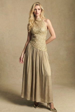 Model in a gold lace halter midi dress shown from a three-quarter angle, highlighting the sculpted lace bodice and fluid drape of the midi skirt.