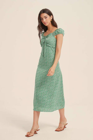 Side walking view of green ditsy-floral midi dress with cap sleeves and tie-front bodice
