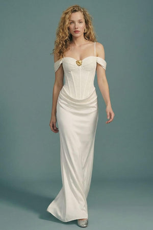 Model walking in an off-shoulder ivory corset maxi dress, highlighting the fluid drape of the satin skirt, fitted lace bodice, and understated elegant silhouette.