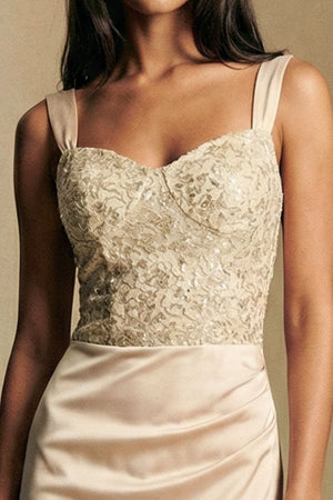 Close-up of the ivory embroidered bodice on a satin maxi dress, highlighting intricate texture, subtle sheen, and structured neckline.