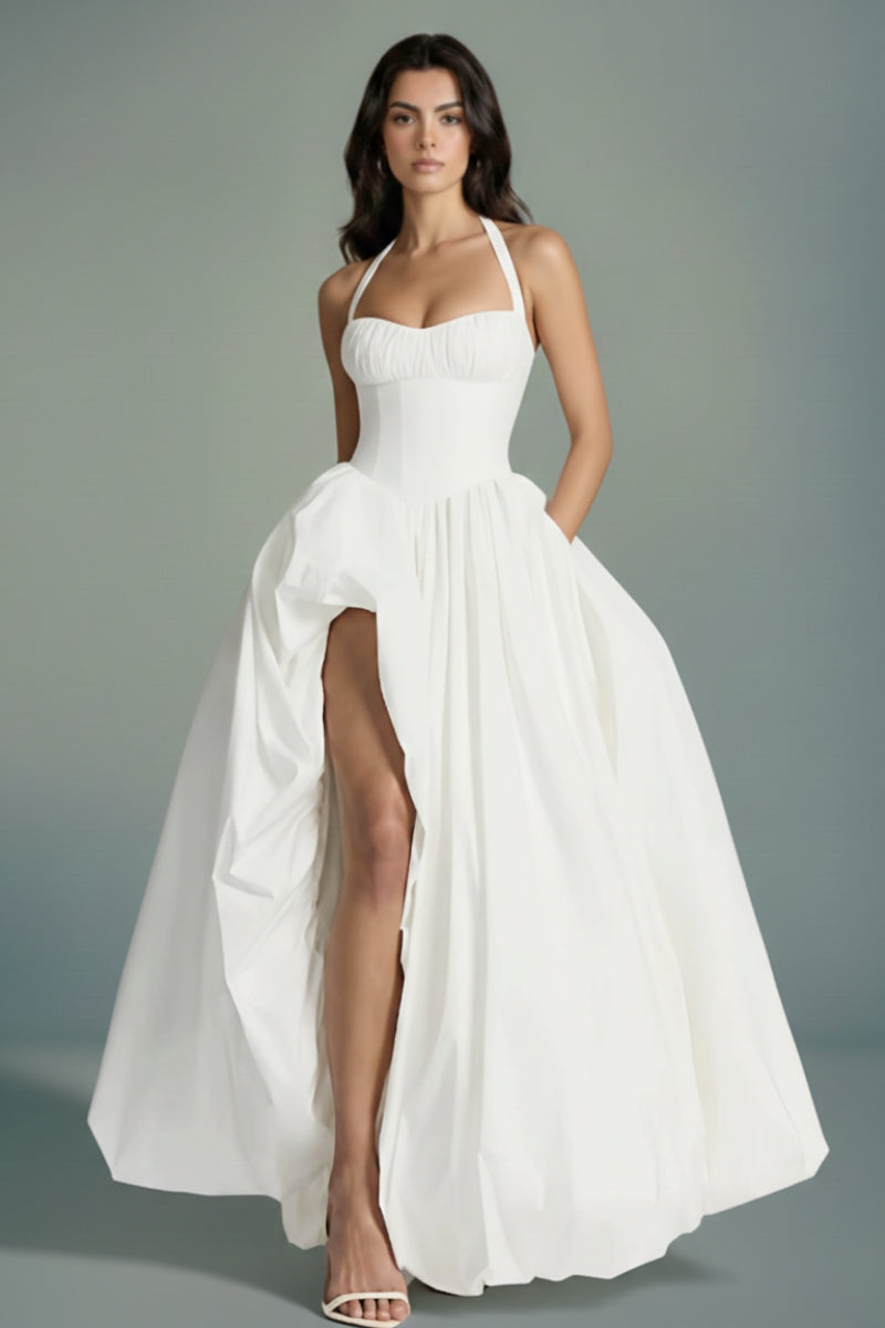 Model in an ivory halter-neck corset maxi dress featuring a structured waist and flowing full skirt, shown from a slightly angled front view for elegant movement.